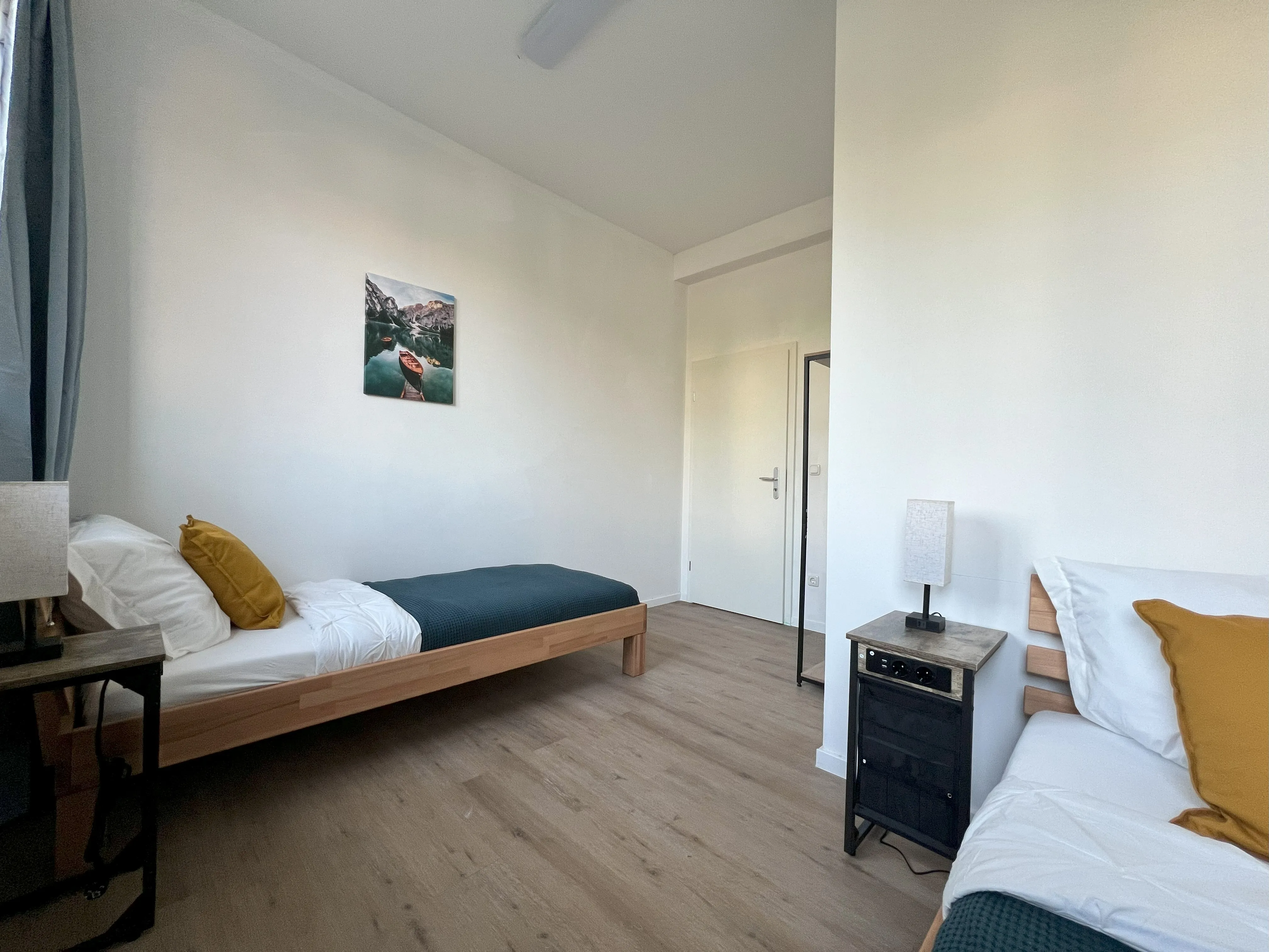Zwei Betten mit Nachttischen
